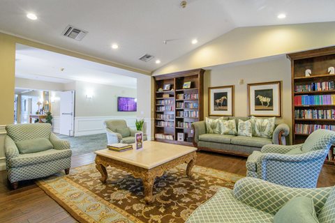 A living room with a sofa, armchair, and coffee table.